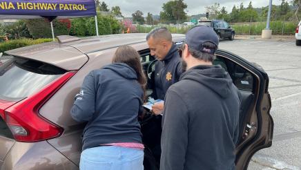 Officer helps parent install car seat