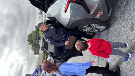 Officer helps parent install car seat