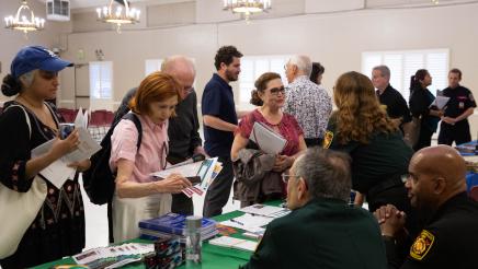 Photo of attendees speaking with Los Feliz Neighborhood Council, CalFire, and other representatives during the open house.
